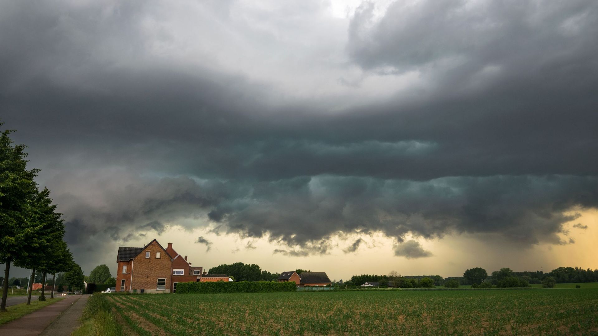 Ominous sky as the gust front of a severe thunderstorm is moving fast over the landscape of eastern Flanders, Belgium